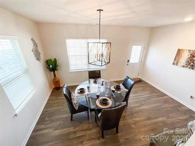 dining area with baseboards and dark wood finished floors