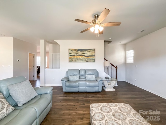 living room featuring visible vents, stairs, a ceiling fan, and wood finished floors