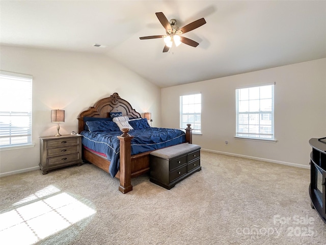 bedroom with baseboards, light carpet, and vaulted ceiling