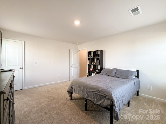 bedroom with visible vents, light colored carpet, and baseboards