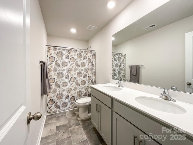 full bath with double vanity, visible vents, and a sink