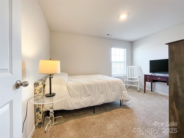 bedroom with carpet, visible vents, and baseboards