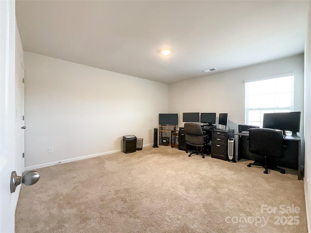 office with visible vents, baseboards, and carpet flooring