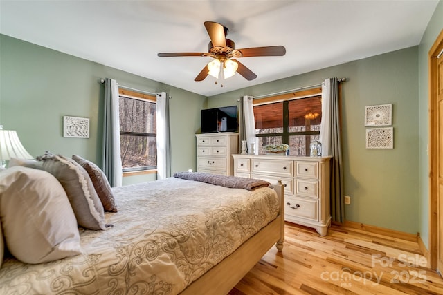 bedroom with light wood-type flooring and a ceiling fan