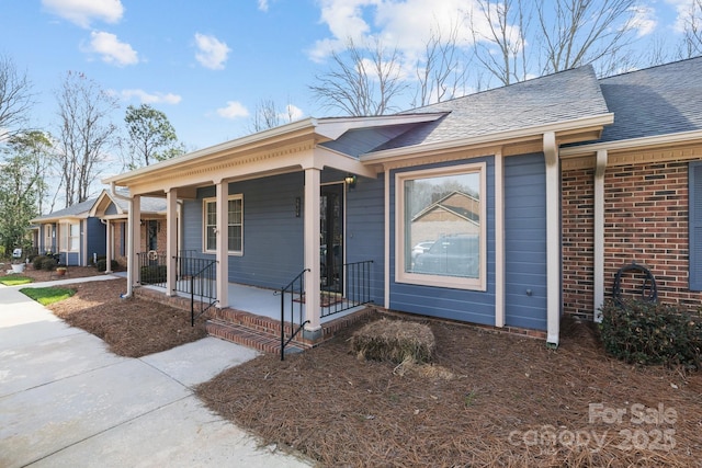 ranch-style house featuring a porch and a shingled roof