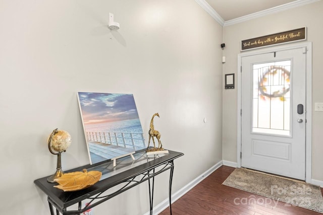 foyer entrance featuring dark wood finished floors, baseboards, and ornamental molding