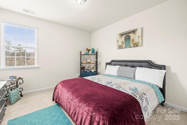 bedroom with visible vents, baseboards, and carpet