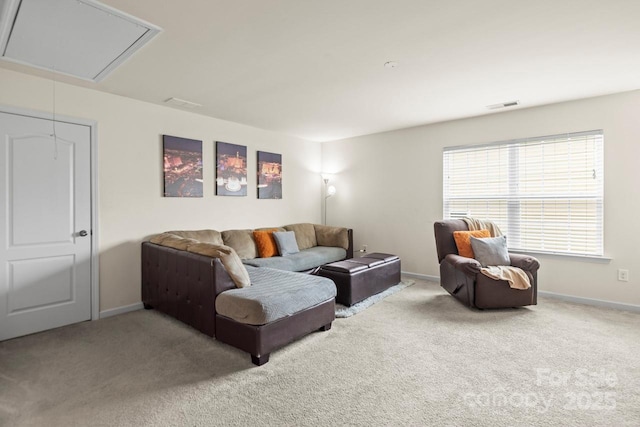 living room featuring visible vents, carpet flooring, attic access, and baseboards