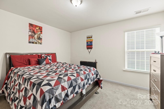 carpeted bedroom with visible vents and baseboards