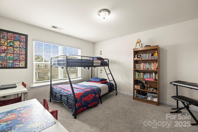 carpeted bedroom featuring visible vents and baseboards