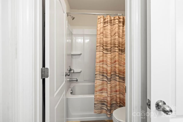 full bathroom featuring shower / tub combo and toilet