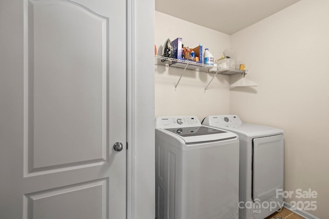 washroom featuring washing machine and clothes dryer and laundry area