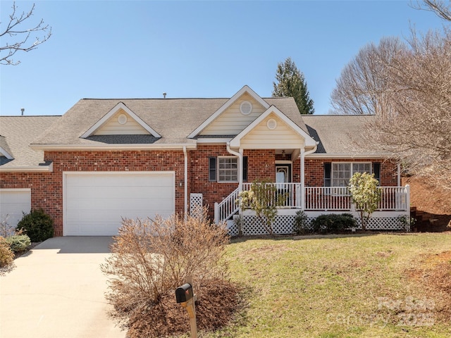 view of front of home featuring brick siding, a porch, and a front yard