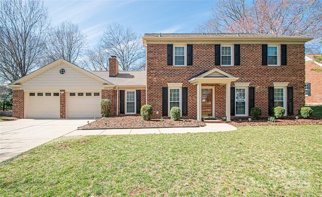 view of front of property featuring a front lawn, brick siding, a garage, and driveway