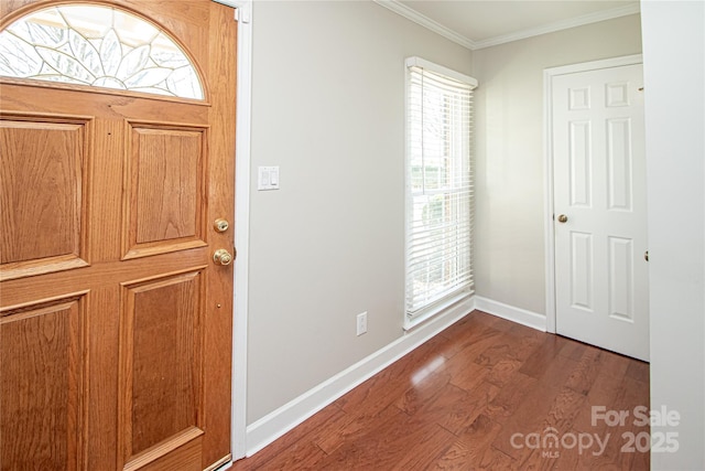 entrance foyer featuring crown molding, baseboards, and wood finished floors