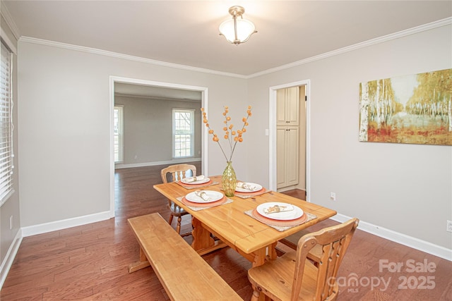 dining room featuring baseboards, light wood-style floors, and ornamental molding