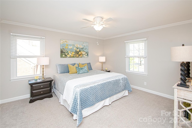 carpeted bedroom featuring baseboards, a ceiling fan, and crown molding