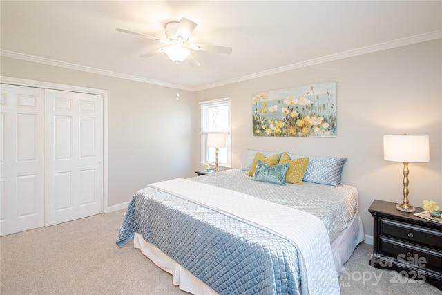 carpeted bedroom featuring a closet, baseboards, crown molding, and a ceiling fan