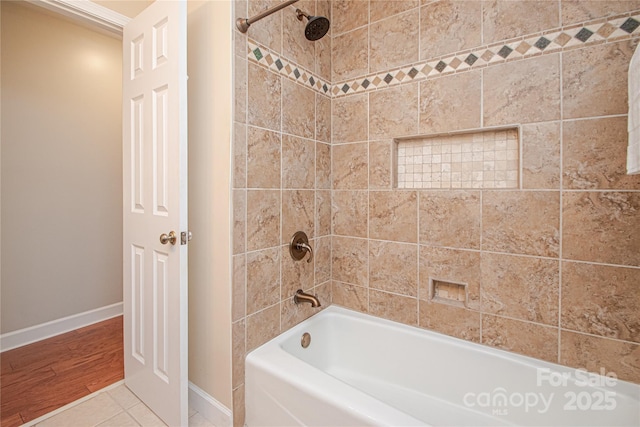 bathroom with tile patterned flooring, shower / tub combination, and baseboards