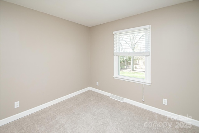 empty room featuring visible vents, baseboards, and carpet floors