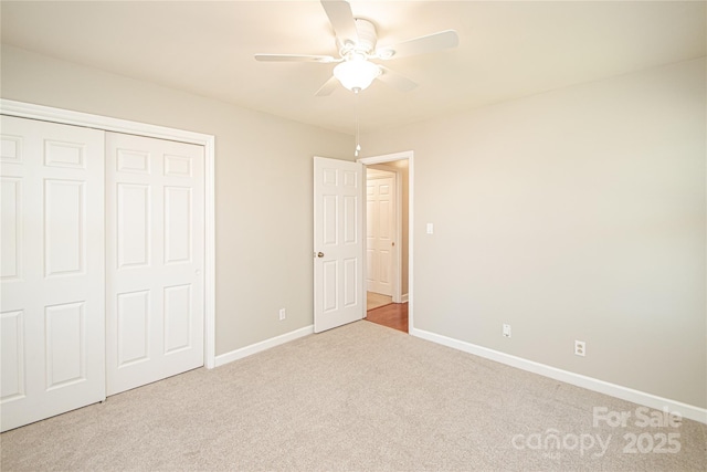 unfurnished bedroom featuring a closet, ceiling fan, baseboards, and carpet