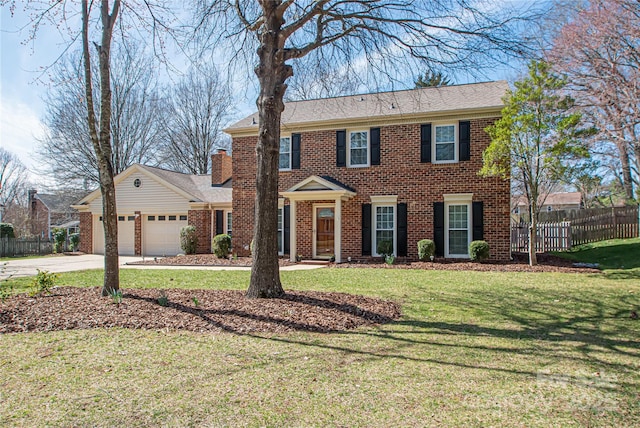 colonial inspired home featuring a garage, brick siding, a front yard, and fence