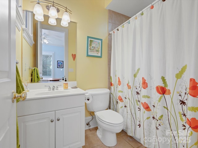 bathroom with a shower with curtain, toilet, a ceiling fan, tile patterned flooring, and vanity