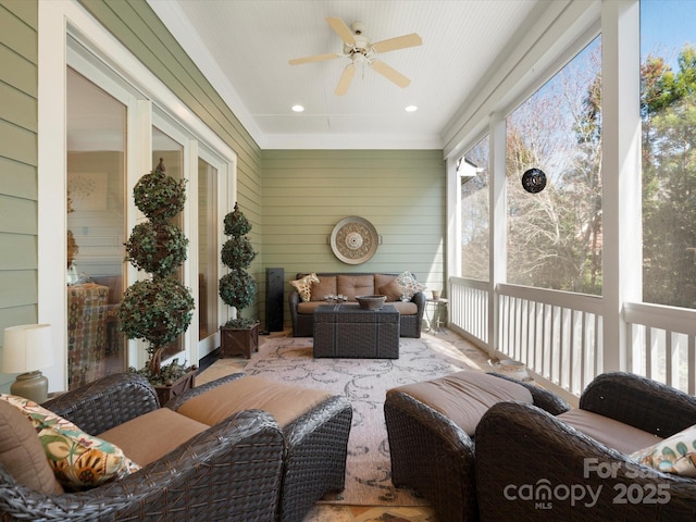 sunroom featuring ceiling fan