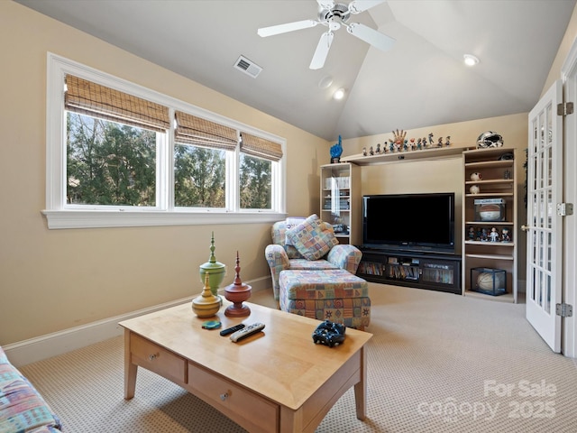 carpeted living room featuring visible vents, lofted ceiling, baseboards, and ceiling fan