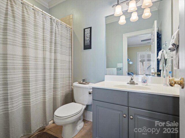 bathroom with tile patterned floors, toilet, vanity, and ornamental molding