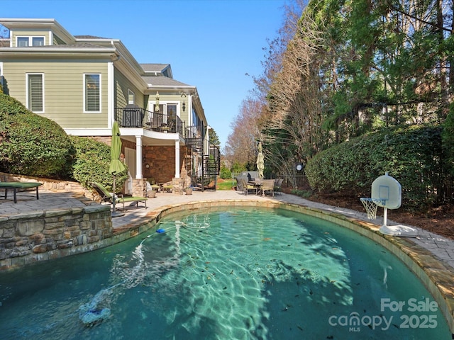 pool with stairs and a patio