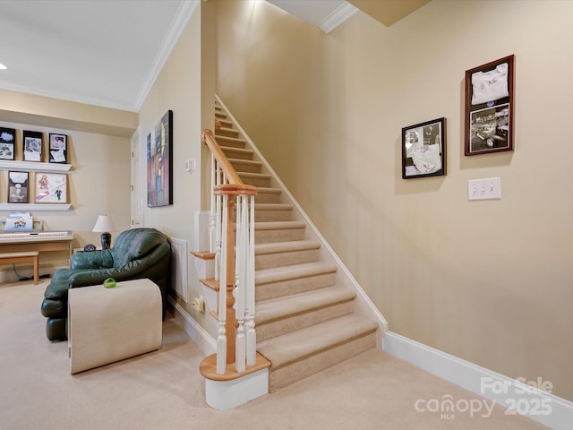 staircase with carpet flooring, baseboards, crown molding, and visible vents