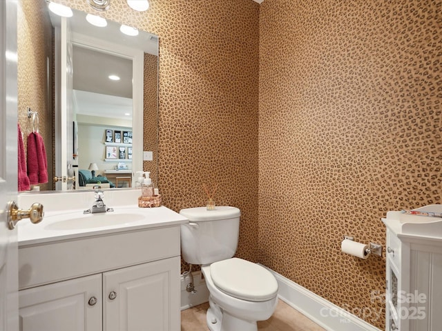 half bathroom with tile patterned flooring, toilet, and vanity