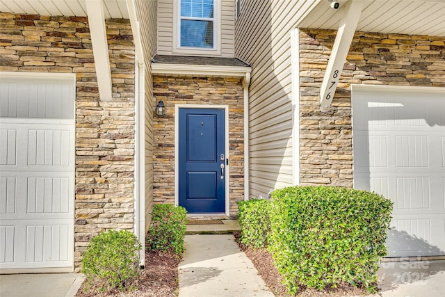 doorway to property with stone siding