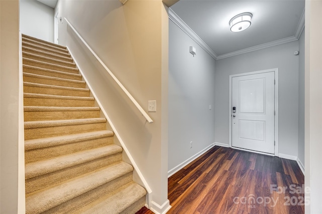 entryway with stairs, baseboards, ornamental molding, and dark wood-style flooring