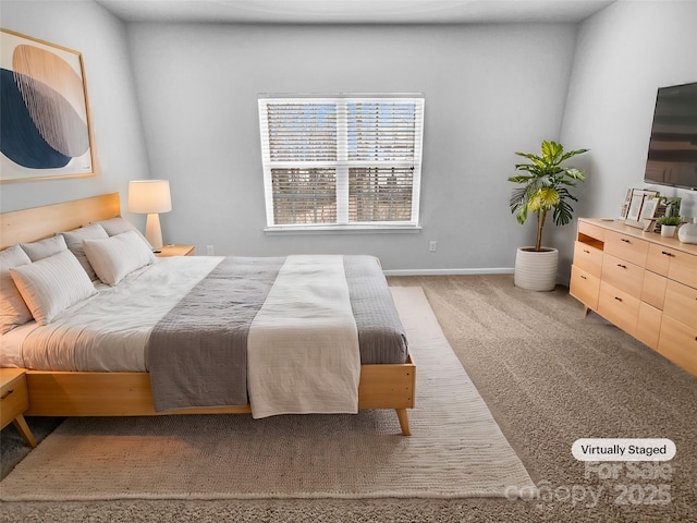 carpeted bedroom featuring baseboards