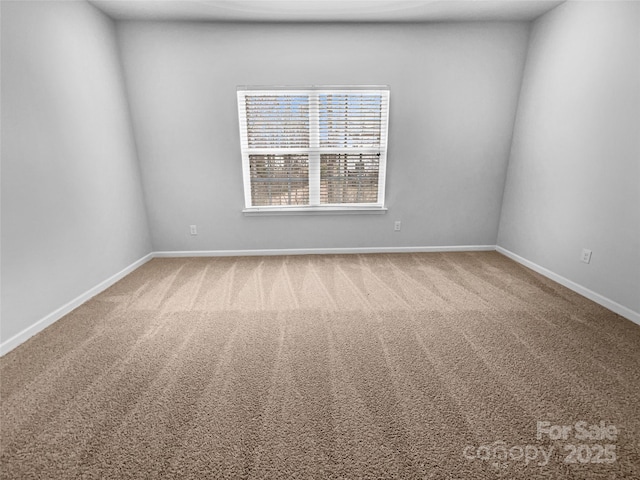 unfurnished room featuring baseboards and carpet floors