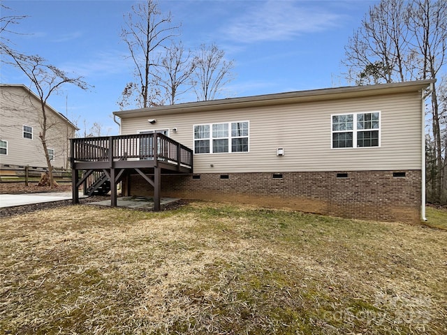 rear view of house with crawl space, stairway, a wooden deck, and fence