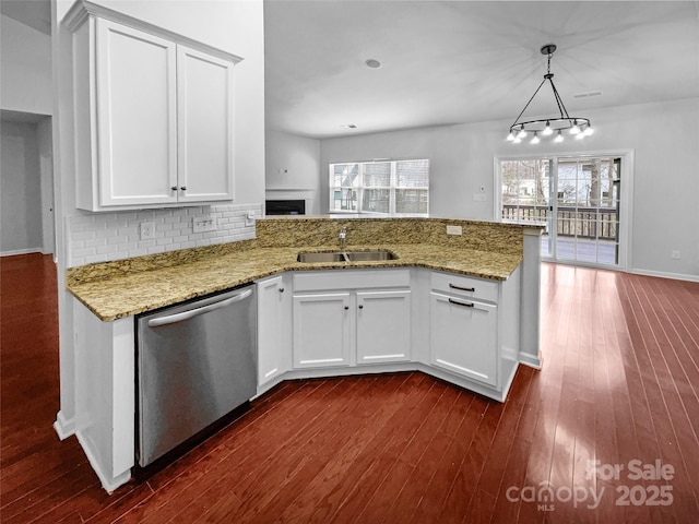 kitchen with a wealth of natural light, a sink, a peninsula, and stainless steel dishwasher