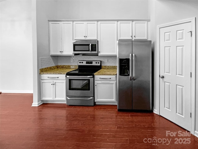 kitchen featuring dark wood-type flooring, white cabinets, tasteful backsplash, and appliances with stainless steel finishes