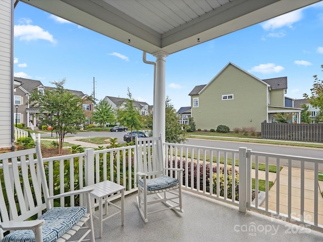 balcony featuring a residential view and a porch