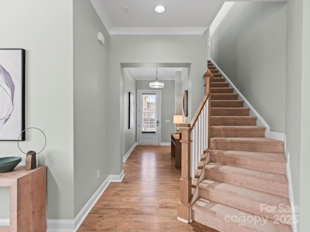 foyer entrance with baseboards, stairs, ornamental molding, recessed lighting, and wood finished floors