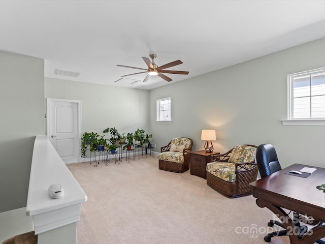 carpeted home office with visible vents and a ceiling fan