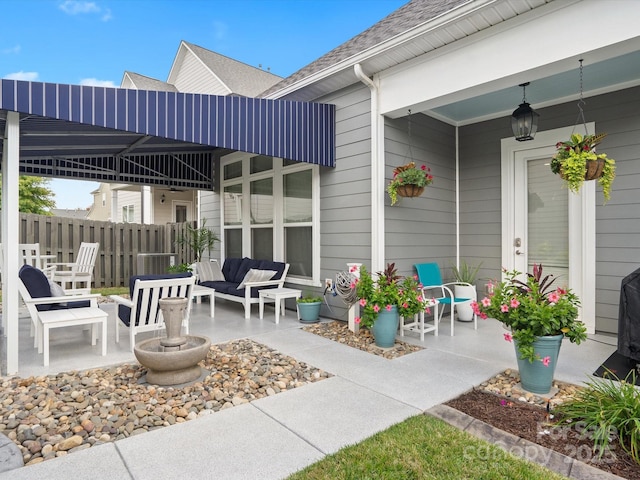 view of patio with outdoor lounge area and fence