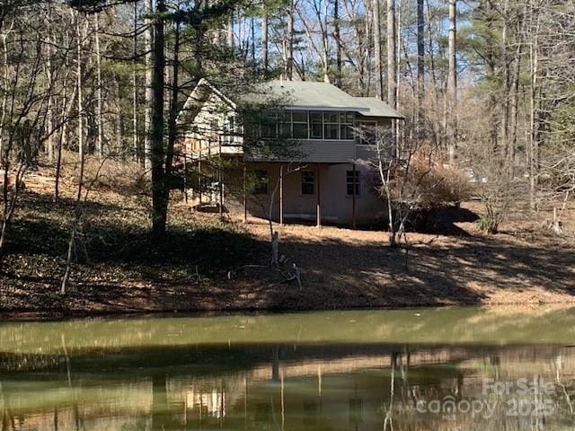 back of house with a water view and a sunroom