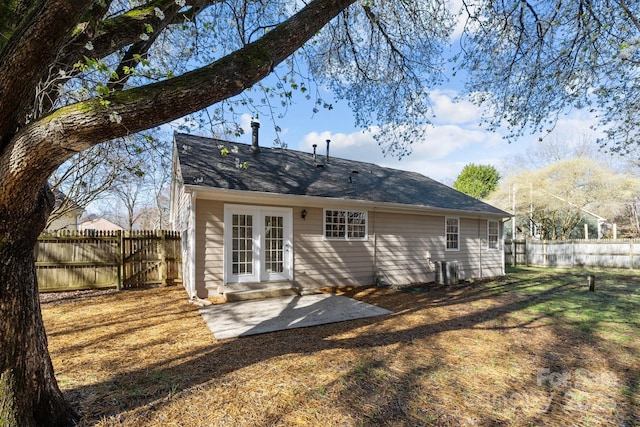 back of property with french doors, entry steps, a fenced backyard, and a patio area