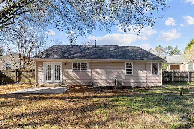 rear view of house featuring a lawn, a patio, and a fenced backyard