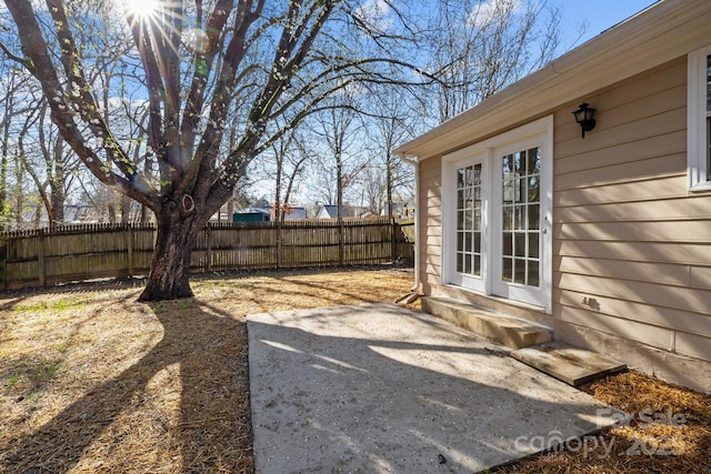 view of yard featuring entry steps and fence