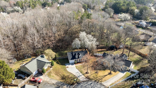 birds eye view of property with a view of trees