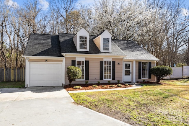 cape cod house with a front lawn, fence, concrete driveway, an attached garage, and a shingled roof